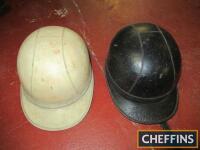 Everoak, a pair of 1950s peak crash helmets, one black, one white