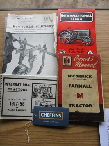 Assortment of International books, including Farmall M manual