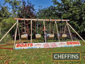 A set of 4 juvenile swing-boats, wooden construction and complete with sign board