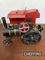 A vintage clockwork traction engine, together with a threshing drum, both of antique manufacture