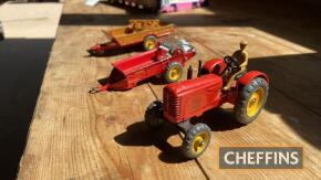 Massey-Harris tractor, together with driver, Hales Owen farm trailer with raves, Massey-Harris manure spreader, all Dinky Toys