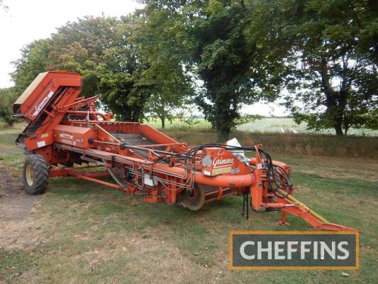 1988 Grimme Q Continental 1500 wide trailed harvester set up for onion harvesting, onion shares and hydraulic headland gate, 1st main web, followed by haulm roller feeding second web with haulm roller, two rows of rubber finger stars feeding third web wit