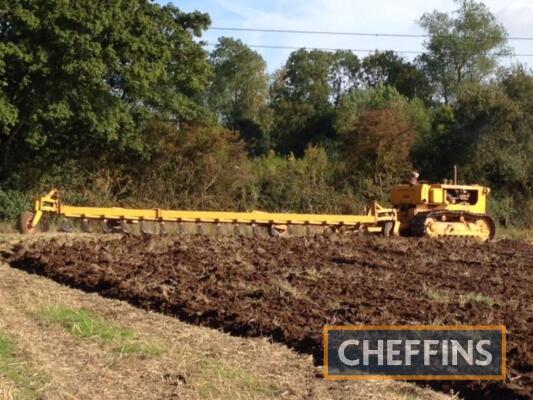 Farm-made 17furrow trailed conventional plough.