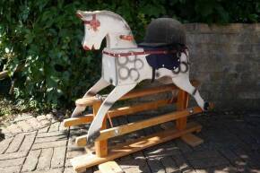 Tri-ang childs wooden rocking horse on static wooden frame with period riding hat, c1950s/60s