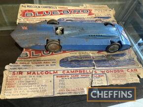 Sir Malcolm Cambell's Famous Blue-Bird, a clockwork tin plate car bearing a facsimile signature, some rust and dents. Complete with the orginal box remains, 16ins long