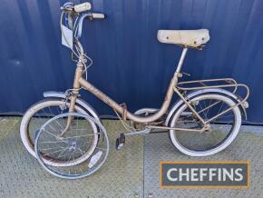 Hercules Folda folding bicycle fitted with Sturmey Archer 3speed hub, luggage rack and bell c.1981 t/w spare set of wheels