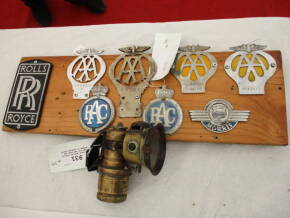 Millers Carbide bicycle lamp t/w assorted car badges on display board