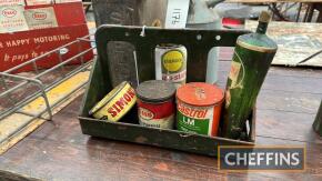 Esso, Castrol and Simoniz, 3no. tins and a tube together with a wall mounted storage rack