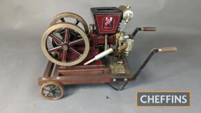 Scale model air cooled horizontal open crank stationary engine with twin flywheels on trolley. With Wyvern decals. Flywheel diameter 7ins each. Appears to be wired up for electric power. Direct from the estate of award-winning model maker Ian Glasspool