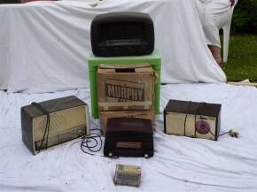 Four Bakelite/plastic radios; to include an accumulator, 3 Mullard valves and Osram valve