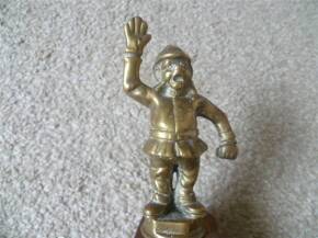 Brass bonnet mascot in the form of a jolly moustachioed policeman in the 'Halt' position