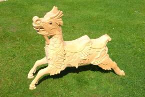 A wooden juvenile size galloping Dragon in the style of Orton & Spooner. Very ornately carved and fitted with glass eyes