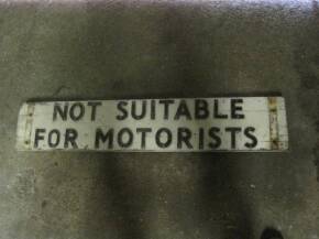 'Not suitable for Motorists' an original wooden sign with aluminium lettering, double sided