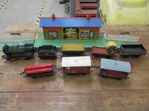 Hornby O gauge Wembley station, locomotive and tender in green, brake van (2), McAlpine tip wagon, gas cylinder wagon, flat truck and cable drum and coal wagon