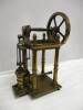 An early model side mount overcrank steam table engine understood to have been built c1850. The 4 column model is of mainly brass construction, the turned columns with acorn finials support the crankshaft and brass flywheel, hand made square headed nuts a