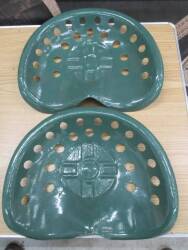 A pair of tin tractor/implement seats