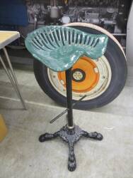 Cast iron seat mounted as a bar stool