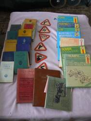 Selection of motoring handbooks and manuals plus road sign beer mats