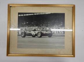 Framed and glazed photo of Jim Clark winning the British Grand Prix at Silverstone, July 11th 1963, by P.G.P Mason-Blake, annotated on rear