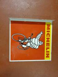 Michelin pictorial double sided printed, flanged sign depicting Bibendum cycling, 17.5x17ins