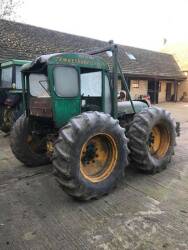 COUNTY Four-Drive 4cylinder diesel TRACTOR Fitted with a front dozer blade and cab. This skid steered tractor is essentially a crawler on pneumatic tyres and was developed in 1954 for the Puerto Rican sugar cane industry, which requested a wheeled tractor