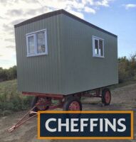 Shepherds hut of modern construction based on a hay trailer chassis with pneumatic wheels. A consumer unit fitted, wiring requiring finishing, a blank shell that is fully insulated, decorated and fitted with a Firestone rubber roof and double glazed windo
