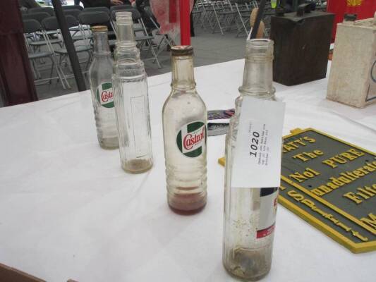 Castrol oil bottles c/w top (2) t/w Esso oil bottles (2)